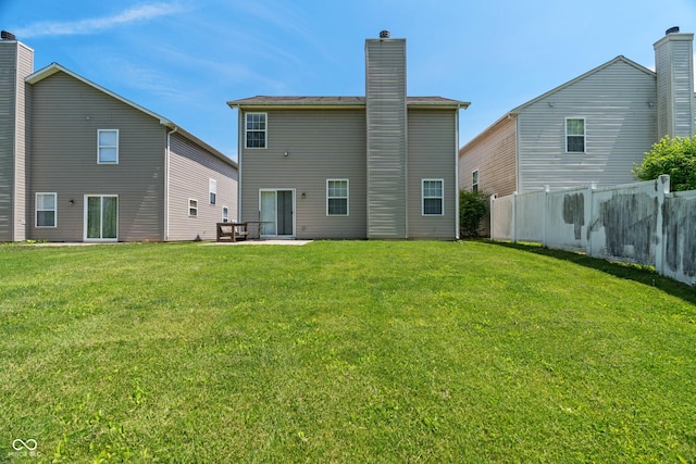 4136 Orchard Valley Ln, Indianapolis, IN 46235 - back of property featuring a chimney and a patio area