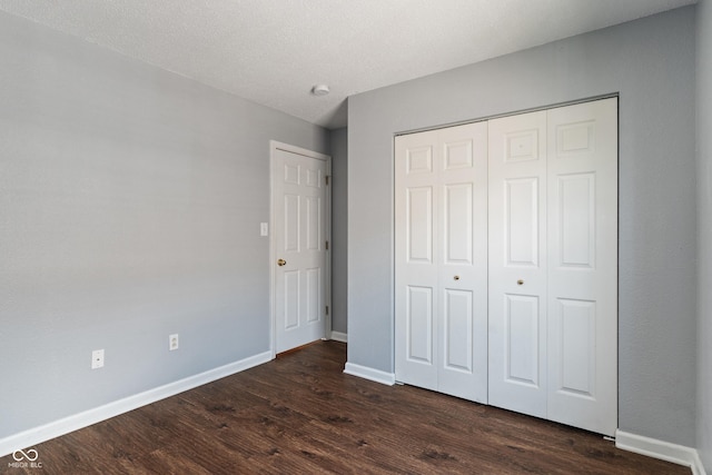 4136 Orchard Valley Ln, Indianapolis, IN 46235 - unfurnished bedroom featuring dark wood-style flooring, baseboards, and a closet