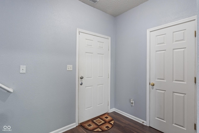 4136 Orchard Valley Ln, Indianapolis, IN 46235 - entrance foyer with dark wood-style flooring, baseboards, and a textured ceiling