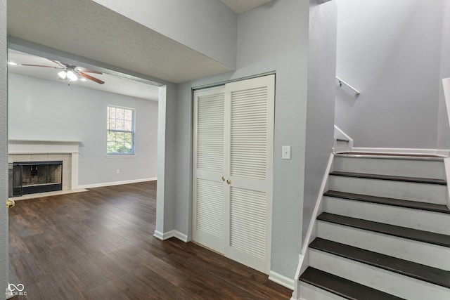 4136 Orchard Valley Ln, Indianapolis, IN 46235 - stairs with wood finished floors, ceiling fan, a tiled fireplace, and baseboards