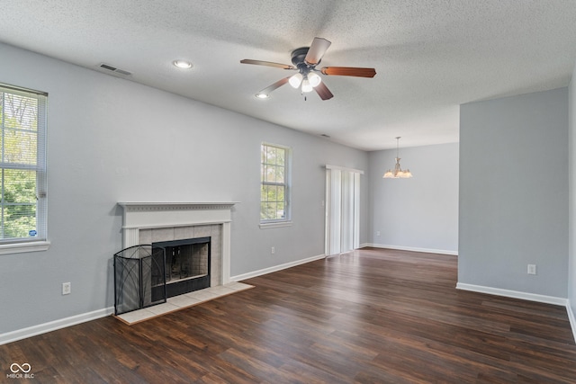 4136 Orchard Valley Ln, Indianapolis, IN 46235 - unfurnished living room with a tiled fireplace, a chandelier, wood finished floors, ceiling fan, and a textured ceiling