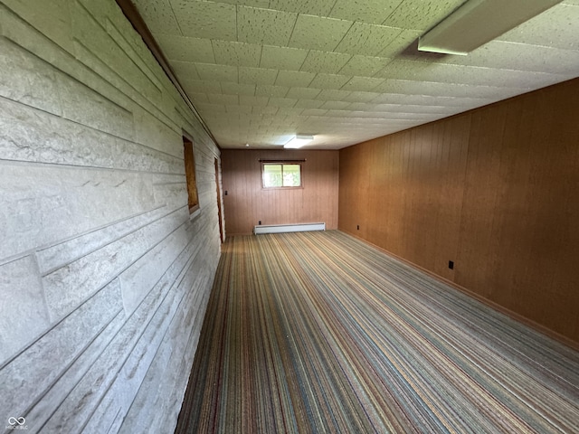1314 E Orange Pike, Rushville, IN 46173 - unfurnished room with wood walls, a baseboard heating unit, and carpet