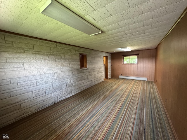 1314 E Orange Pike, Rushville, IN 46173 - carpeted empty room featuring a baseboard radiator and wooden walls