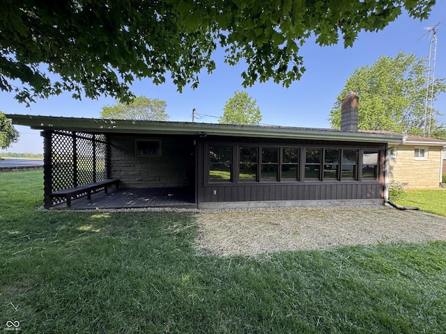 1314 E Orange Pike, Rushville, IN 46173 - back of house with a chimney, a lawn, and a deck