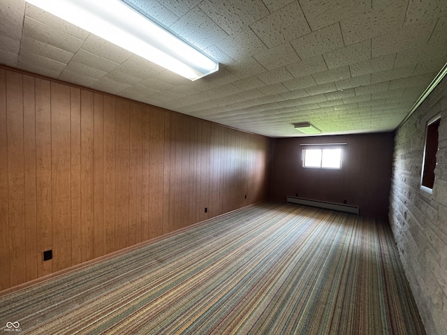1314 E Orange Pike, Rushville, IN 46173 - carpeted empty room featuring baseboard heating and wood walls