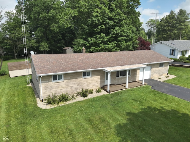 1314 E Orange Pike, Rushville, IN 46173 - single story home featuring stone siding, driveway, a garage, a front yard, and a porch