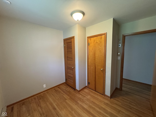 1314 E Orange Pike, Rushville, IN 46173 - unfurnished bedroom with light wood-style flooring and a closet