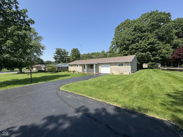 1314 E Orange Pike, Rushville, IN 46173 - ranch-style home featuring driveway, a front lawn, and a garage