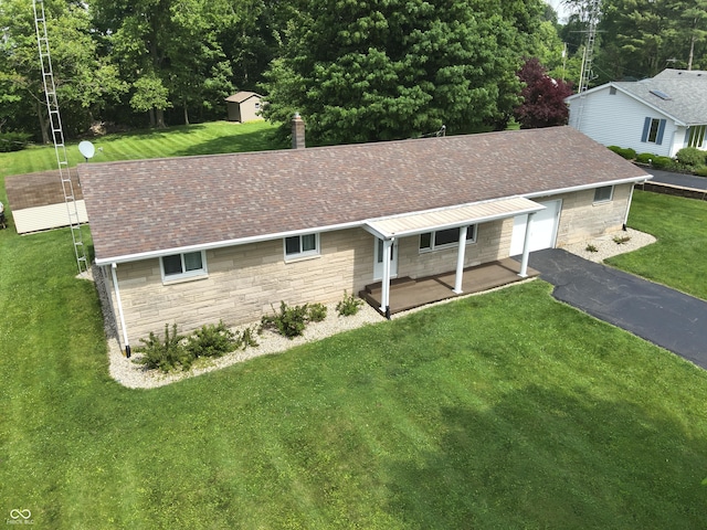 1314 E Orange Pike, Rushville, IN 46173 - view of front of property featuring stone siding, a shed, a front yard, and asphalt driveway