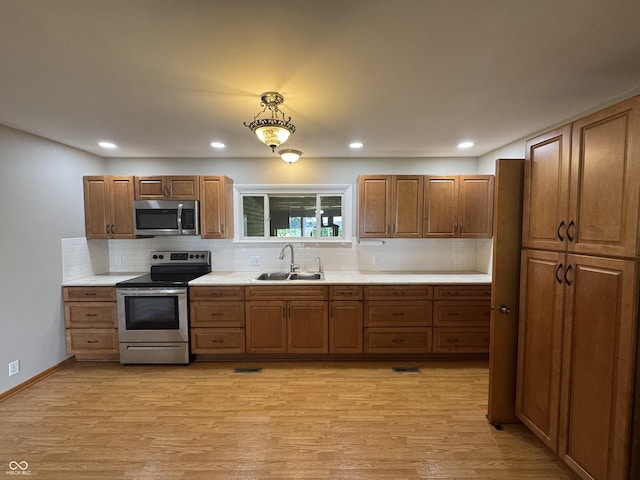 1314 E Orange Pike, Rushville, IN 46173 - kitchen featuring stainless steel appliances, backsplash, light wood-style floors, light countertops, and recessed lighting
