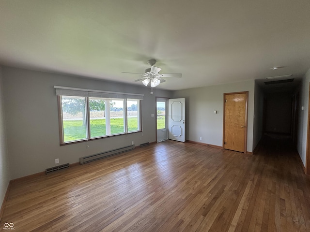 1314 E Orange Pike, Rushville, IN 46173 - spare room featuring a baseboard heating unit, hardwood / wood-style floors, and ceiling fan