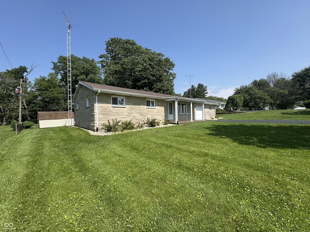 1314 E Orange Pike, Rushville, IN 46173 - view of front of property featuring a front lawn, stone siding, and an attached garage