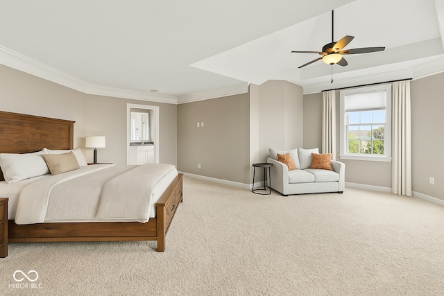 bedroom featuring baseboards, crown molding, light colored carpet, ensuite bathroom, and a ceiling fan