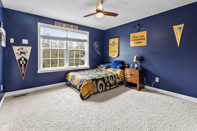 carpeted bedroom featuring baseboards and a ceiling fan