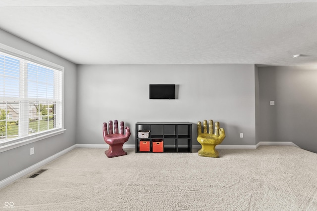 recreation room featuring carpet floors and baseboards