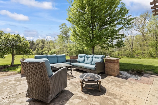 view of patio / terrace with an outdoor living space with a fire pit
