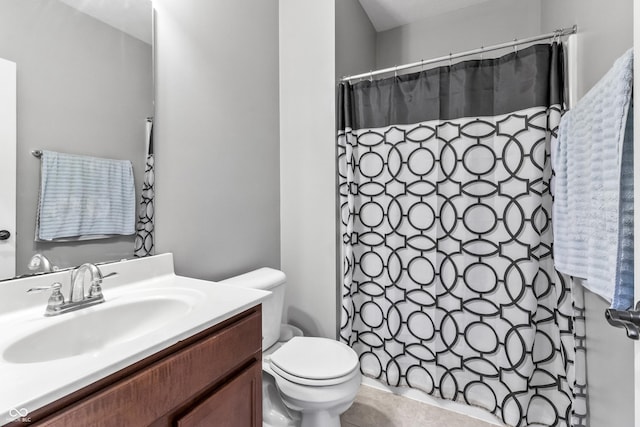 bathroom featuring toilet, vanity, and a shower with curtain