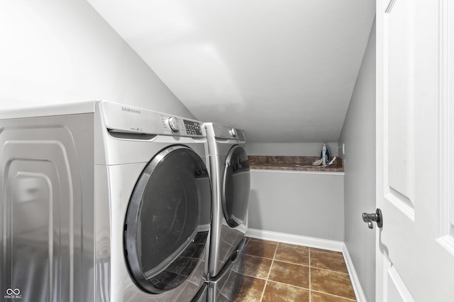 clothes washing area featuring separate washer and dryer and baseboards