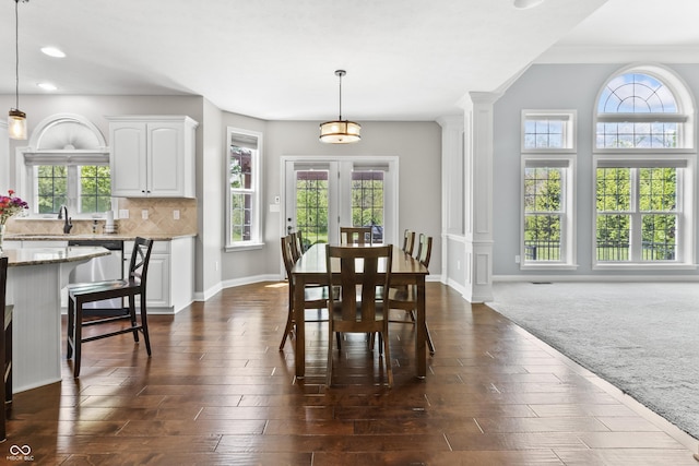 dining room with plenty of natural light, decorative columns, baseboards, and recessed lighting