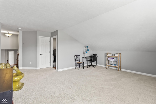 bonus room featuring carpet flooring, baseboards, vaulted ceiling, and a desk