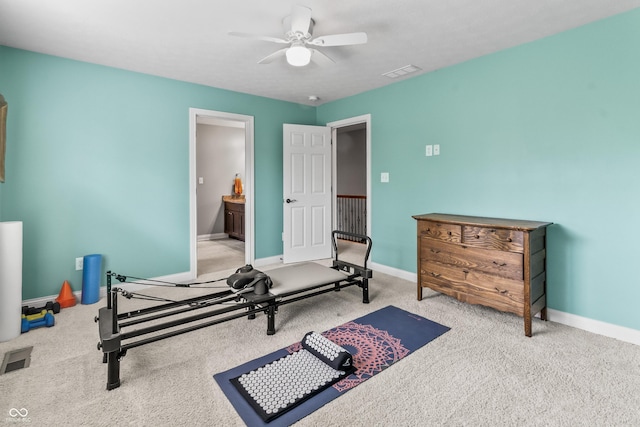 workout area with a ceiling fan, carpet, and baseboards