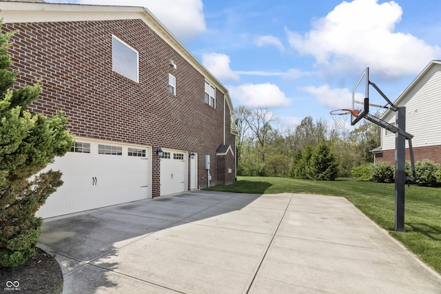 view of property exterior with concrete driveway, a lawn, a garage, and brick siding
