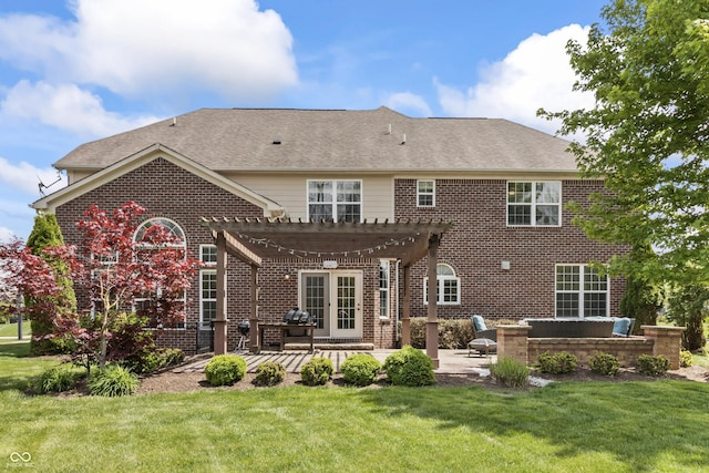 rear view of house featuring a pergola, brick siding, a lawn, a patio, and a shingled roof
