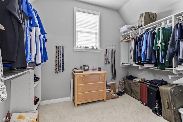 spacious closet featuring carpet flooring and vaulted ceiling