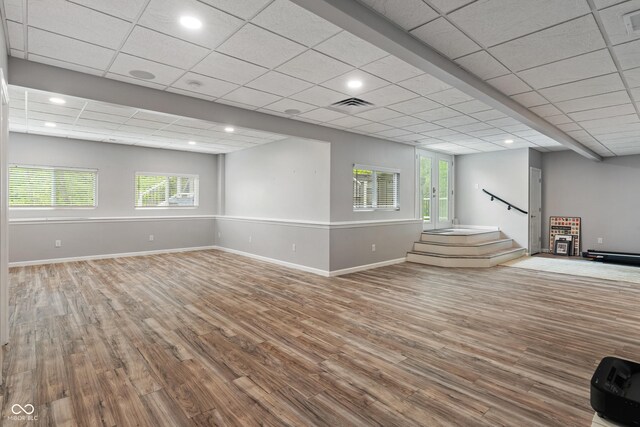 basement featuring wood finished floors, baseboards, recessed lighting, and stairs