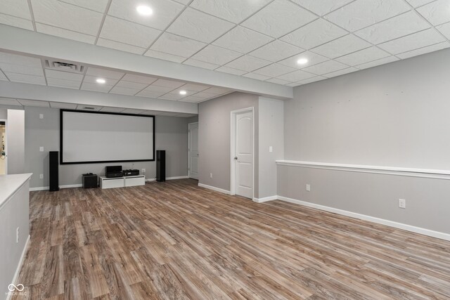 cinema featuring wood finished floors, a paneled ceiling, baseboards, and recessed lighting