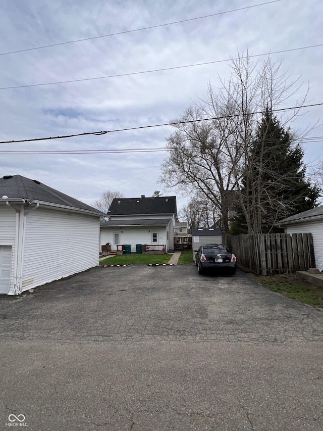 view of front of home with fence and driveway