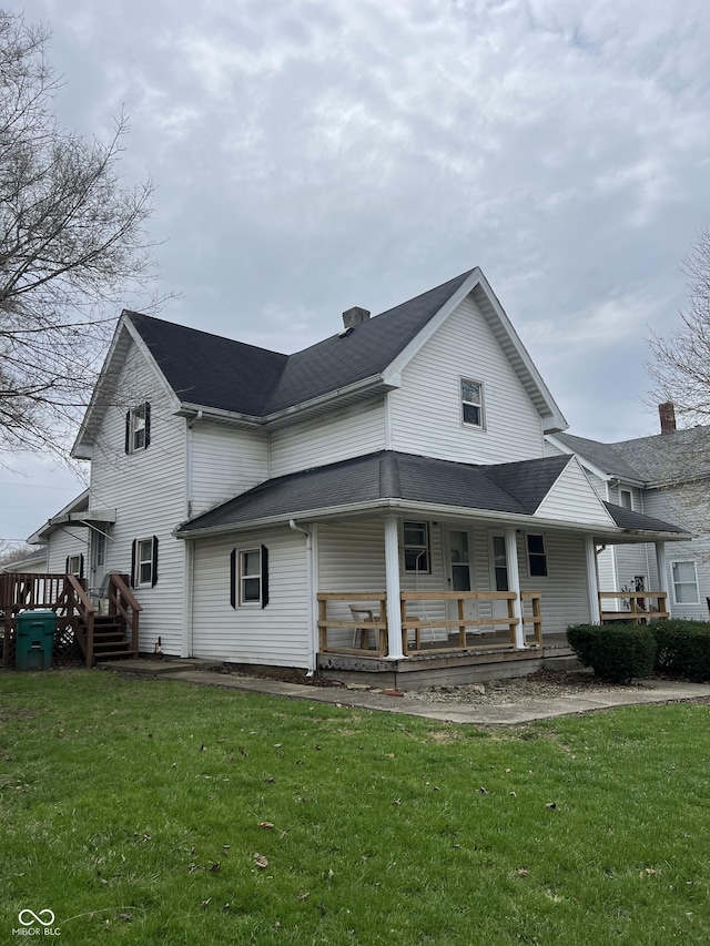 back of house with a yard and covered porch