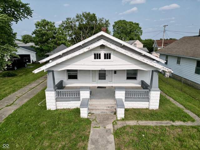 1600 N Washington St, Kokomo, IN 46901 - view of front of property with covered porch, a front yard, and a chimney