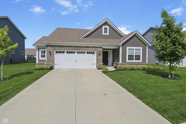 craftsman inspired home featuring a front yard, a garage, concrete driveway, and brick siding