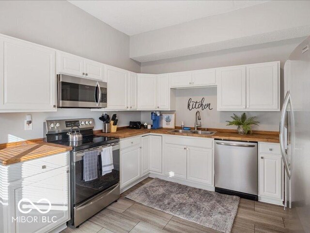 923 S State Ave, Indianapolis, IN 46203 - kitchen featuring stainless steel appliances, a sink, and white cabinets