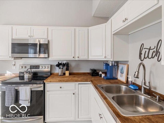 923 S State Ave, Indianapolis, IN 46203 - kitchen featuring appliances with stainless steel finishes, a sink, and white cabinetry