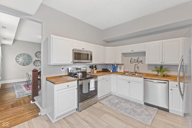 923 S State Ave, Indianapolis, IN 46203 - kitchen featuring stainless steel appliances, a sink, and wood tiled floors