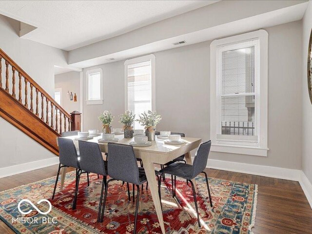 923 S State Ave, Indianapolis, IN 46203 - dining area featuring baseboards, stairway, and wood finished floors