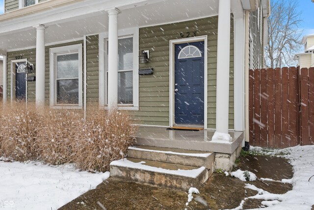 923 S State Ave, Indianapolis, IN 46203 - snow covered property entrance featuring fence and covered porch