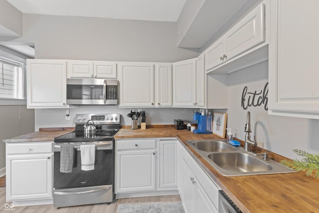 923 S State Ave, Indianapolis, IN 46203 - kitchen featuring stainless steel appliances, a sink, and white cabinetry