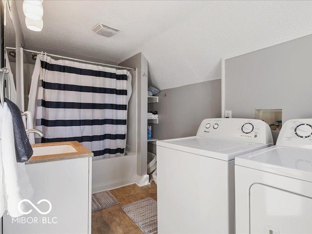 923 S State Ave, Indianapolis, IN 46203 - washroom with washing machine and dryer, wood finished floors, a sink, and a textured ceiling