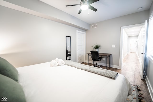 1112 Spann Ave, Indianapolis, IN 46203 - bedroom with wood finished floors, a ceiling fan, an office area, and baseboards