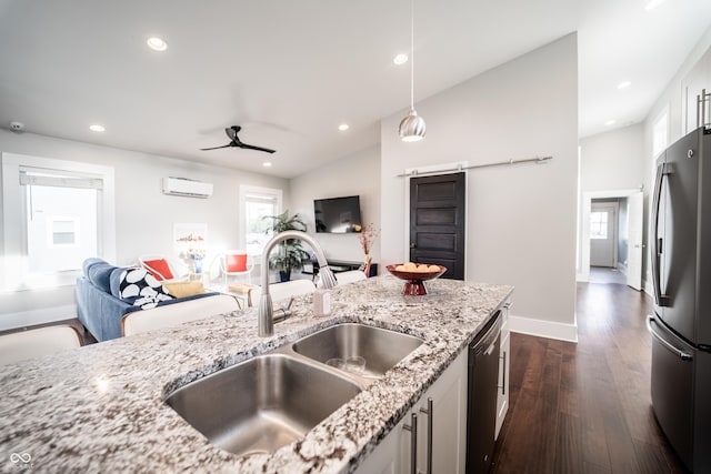 1112 Spann Ave, Indianapolis, IN 46203 - kitchen featuring freestanding refrigerator, a sink, a barn door, dark wood-style flooring, and dishwasher