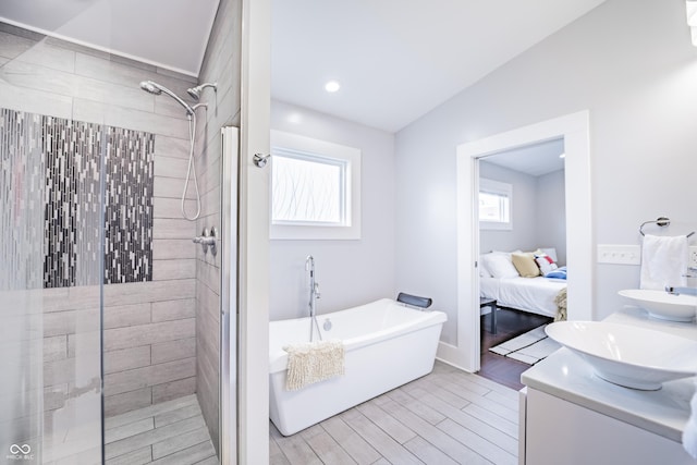 1112 Spann Ave, Indianapolis, IN 46203 - bathroom featuring a tile shower, a freestanding tub, connected bathroom, wood finished floors, and vaulted ceiling