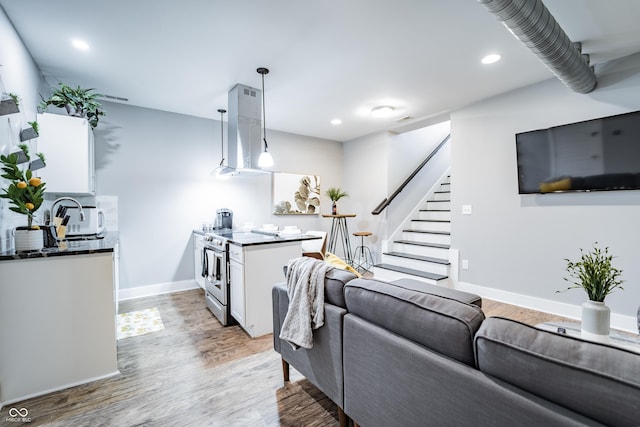 1112 Spann Ave, Indianapolis, IN 46203 - living room featuring stairway, light wood-style flooring, baseboards, and recessed lighting