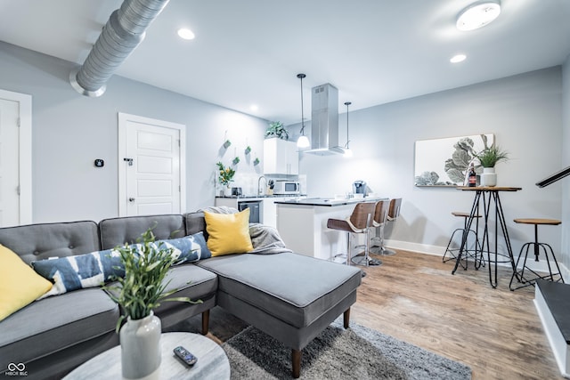 1112 Spann Ave, Indianapolis, IN 46203 - living room featuring wood finished floors, recessed lighting, and baseboards