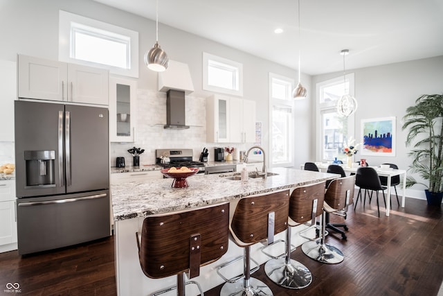 1112 Spann Ave, Indianapolis, IN 46203 - kitchen with appliances with stainless steel finishes, a sink, a breakfast bar, glass insert cabinets, and dark wood-style floors