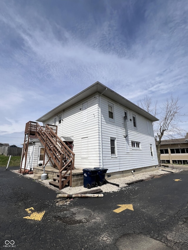 view of side of home with stairway