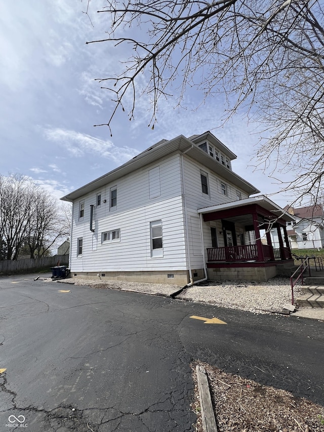 view of home's exterior featuring covered porch and crawl space