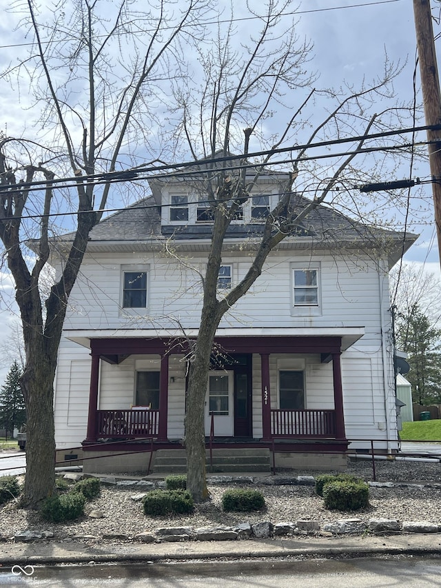 american foursquare style home with covered porch